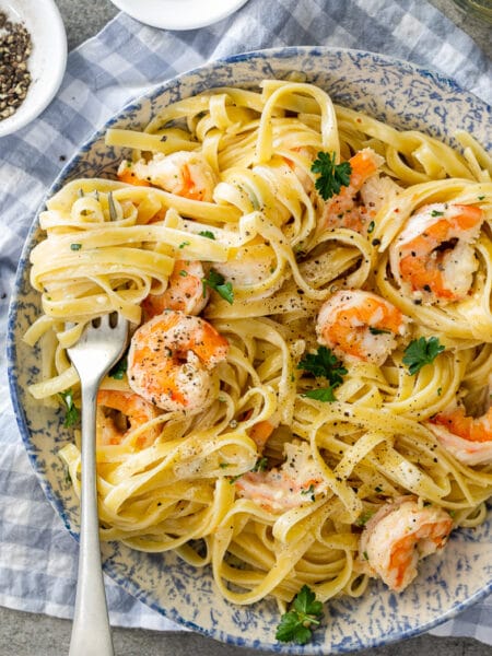 One-pot lemon garlic shrimp pasta served in a skillet with fresh parsley and lemon slices"